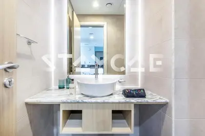 a bathroom with a sink and a mirror at Staycae Holiday Homes - Paramount Midtown in Dubai