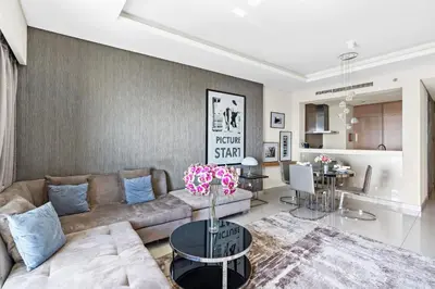 a living room with a couch and a table at ALiving Elegant 1BR I Burj Khalifa View I Paramount Towers- 6103 in Dubai