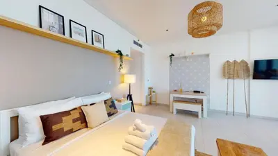 a living room with a couch and a table at Stylish Studio with Burj Khalifa View in Dubai