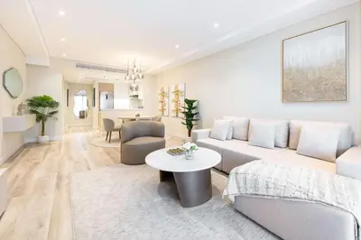 a living room with a couch and a table at Fabulous 1 bedroom apartment at 5 Star Resort in Dubai