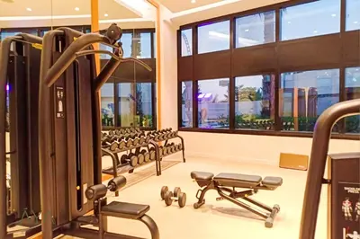 a gym with rows of chairs and equipment in a building at Jumeirah Gate Tower 1 - Stylish Apartment with Pool & City Views By ĀYA Boutique in Dubai