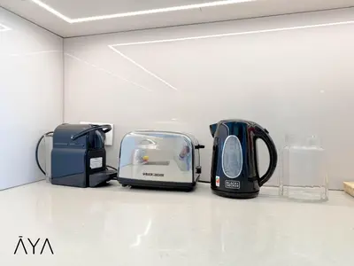 two toasters are sitting on a shelf in a room at Jumeirah Gate Tower 1 - Stylish Apartment with Pool & City Views By ĀYA Boutique in Dubai