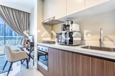 a kitchen with a sink and a microwave at Staycae Holiday Homes - Vera by DAMAC Near Downtown, Business Bay in Dubai