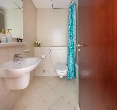 a bathroom with a toilet and a sink at Frank Porter - Icon Tower 1 in Dubai