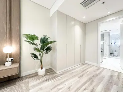 a living room with a plant in a vase at Relaxing 1 bedroom apartment at 5 Star Resort in Dubai
