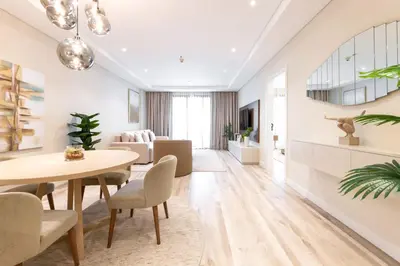a living room with a dining room table and chairs at Relaxing 1 bedroom apartment at 5 Star Resort in Dubai