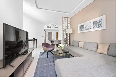 a living room with a couch and a flat screen tv at ALiving Modern 1BR Apartment with Balcony & Canal View I DAMAC Maison Prive A- 517 in Dubai