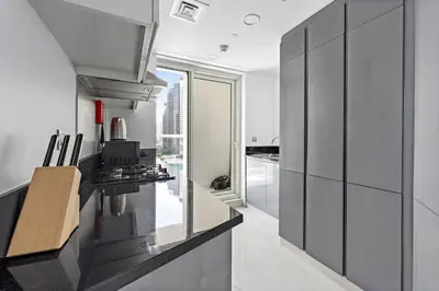 a kitchen with a stove and a counter top at ALiving Modern 1BR Apartment with Balcony & Canal View I DAMAC Maison Prive A- 517 in Dubai