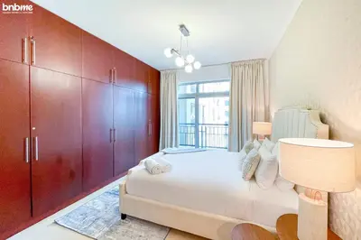 a bedroom with a bed and a large window at bnbmehomes - Túria Tower A in Dubai