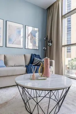a living room with a coffee table in front of a couch at GuestReady - Deluxe Waterfront View in the Marina in Dubai