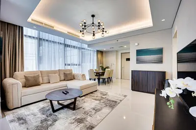 a living room with a couch and a table at Luxury 2 Bedroom in Paramount Midtown Residence in Dubai