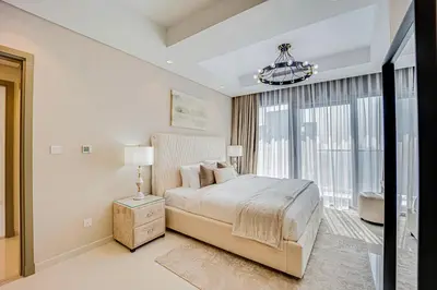 a bedroom with a bed and a large window at Luxury 2 Bedroom in Paramount Midtown Residence in Dubai