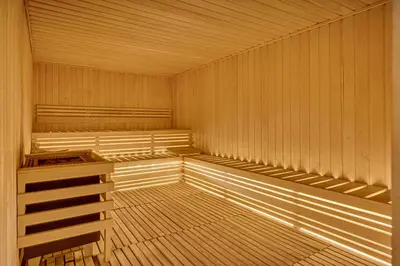 an empty wooden sauna with empty shelves in it at Luxury 2 Bedroom in Paramount Midtown Residence in Dubai