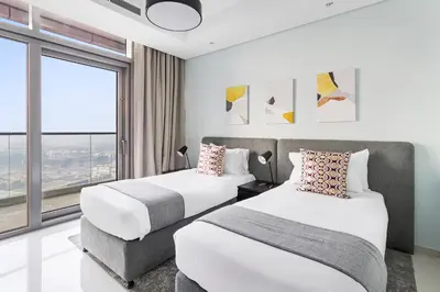 a hotel room with two beds and a window at ALiving Luxe 2BR with higest Infinity Pool Close to Dubai Mall & Burj Khalifa in Dubai