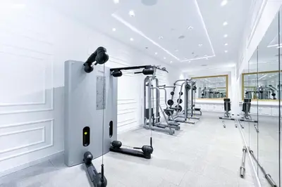 a gym with several treadmills and exercise machines at bnbme - Luxury 2BR Near Burj Khalifa Apt Balcony Pool Gym Concierge Near Dubai Mall in Dubai