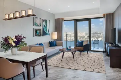 a living room with a couch and a table at Address Creek Harbour in Dubai