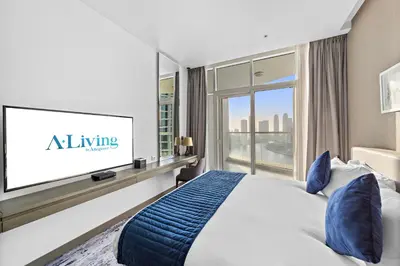 a bedroom with a bed and a flat screen tv at ALiving Luxury Studio with Canal Views I DAMAC Maison Prive 2512 in Dubai