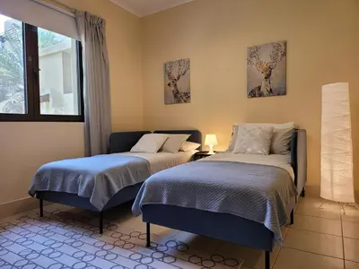 a bedroom with two beds and a window at Luxury 3 Bedroom Apartment - DUBAI MALL 5 min Walk in Dubai