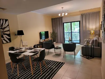 a living room with a table and chairs at Luxury 3 Bedroom Apartment - DUBAI MALL 5 min Walk in Dubai