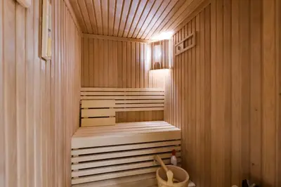 a sauna with a bench in a wooden room at Lovely 1BD canal view apartment in Dubai Marina in Dubai
