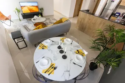 a white table and chairs in a living room at Enticing space With Marina View Near the Beach! in Dubai