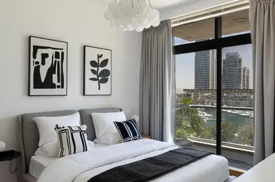 a bedroom with a bed and a large window at Dubai Marina, Two bedrooms apartment with full Marina View in Dubai