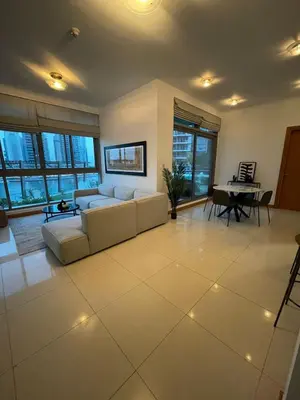 a living room with a couch and a table at Dubai Marina, Two bedrooms apartment with full Marina View in Dubai