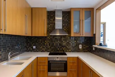 a kitchen with wooden cabinets and a stove top oven at Dubai Marina, Two bedrooms apartment with full Marina View in Dubai