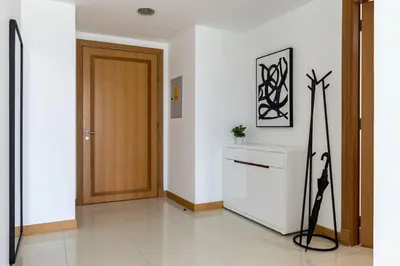 a hallway with a wooden door and a white floor at Dubai Marina, Two bedrooms apartment with full Marina View in Dubai