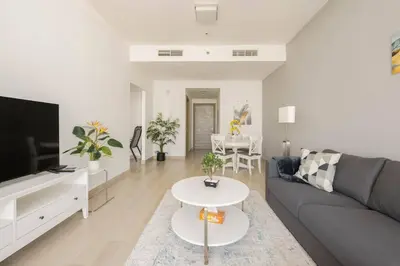 a living room with a couch and a table at High floor 1BR vacation home with terrace in Dubai