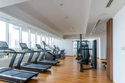 a gym with treadmills and elliptical machines at High floor 1BR vacation home with terrace in Dubai