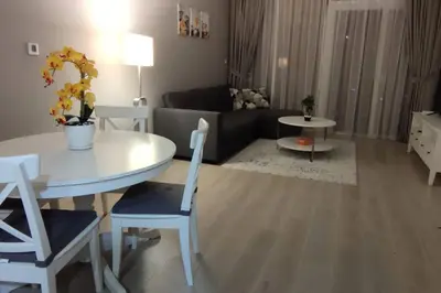 a living room with a table and a couch at High floor 1BR vacation home with terrace in Dubai