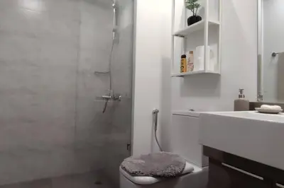 a bathroom with a shower and a toilet and a sink at High floor 1BR vacation home with terrace in Dubai