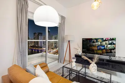 a living room with a couch and a large window at Stunning Space with Full Marina View in Dubai