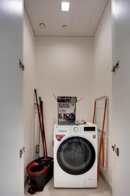 a laundry room with a washing machine in a room at Lovely 1 BD apartment in Beach Vista Tower in Dubai