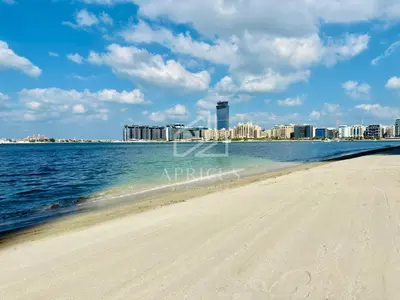 a beach with a city in the background at Lovely 1 BD apartment in Beach Vista Tower in Dubai