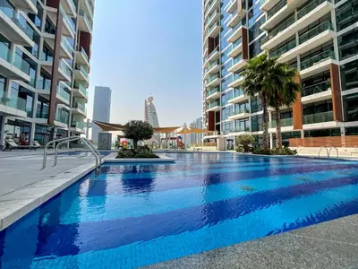 a large swimming pool in the middle of some buildings at HiGuests - Spacious Apt Near Zabeel Park With Panoramic Views in Dubai