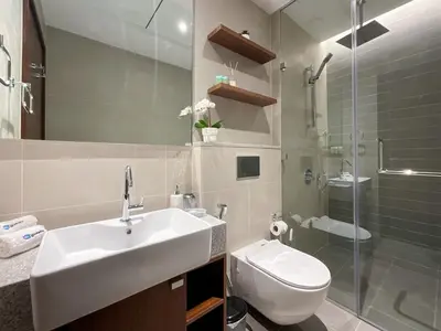 a bathroom with a sink and a toilet and a shower at HiGuests - Spacious Apt Near Zabeel Park With Panoramic Views in Dubai