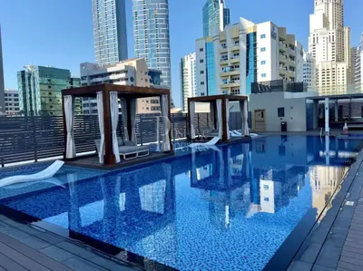 a swimming pool on the roof of a building at Studio One - Beautiful One Bedroom in Dubai