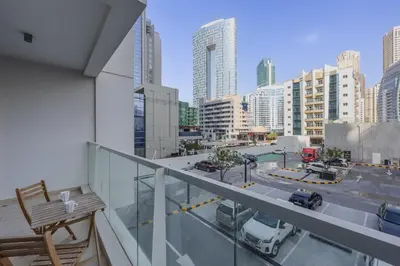 a balcony with a view of a city with buildings at Studio One - Beautiful One Bedroom in Dubai