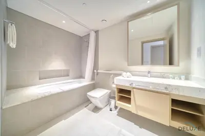 a bathroom with a sink toilet and a mirror at Peaceful 1BR at Creek Rise Tower 2 Dubai Creek Harbour by Deluxe Holiday Homes in Dubai