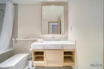 a bathroom with a sink and a toilet and a mirror at Peaceful 1BR at Creek Rise Tower 2 Dubai Creek Harbour by Deluxe Holiday Homes in Dubai