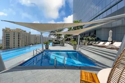 a swimming pool on the roof of a building at FAM Living - Palm Tower - Palm Jumeirah - Panoramic Studios in Dubai