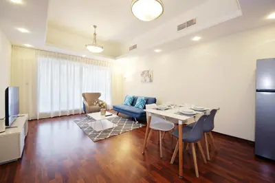 a kitchen and living room with a table and chairs at RH- Lovely 1BR apartment in JLT, near metro in Dubai