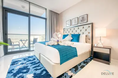 a bedroom with a bed with a large window at Peaceful Studio at Celestia A Dubai South by Deluxe Holiday Homes in Dubai