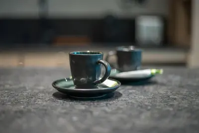 two coffee cups sitting on a table at Modern flat with KING SIZE bed and HIGH SPEED Wifi in Dubai