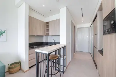 a kitchen with a counter and a stool in a room at Fantastic Studio resort style facilities - OFFER in Dubai