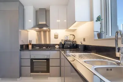 a kitchen with a sink and a stove top oven at At The Top Burj View STUDIO - Special offer in Dubai