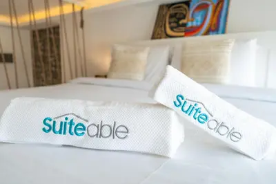 two white pillows on a bed in a room at Unique loft with smart working station in Dubai