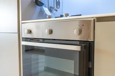 a stainless steel oven in a kitchen at Unique loft with smart working station in Dubai